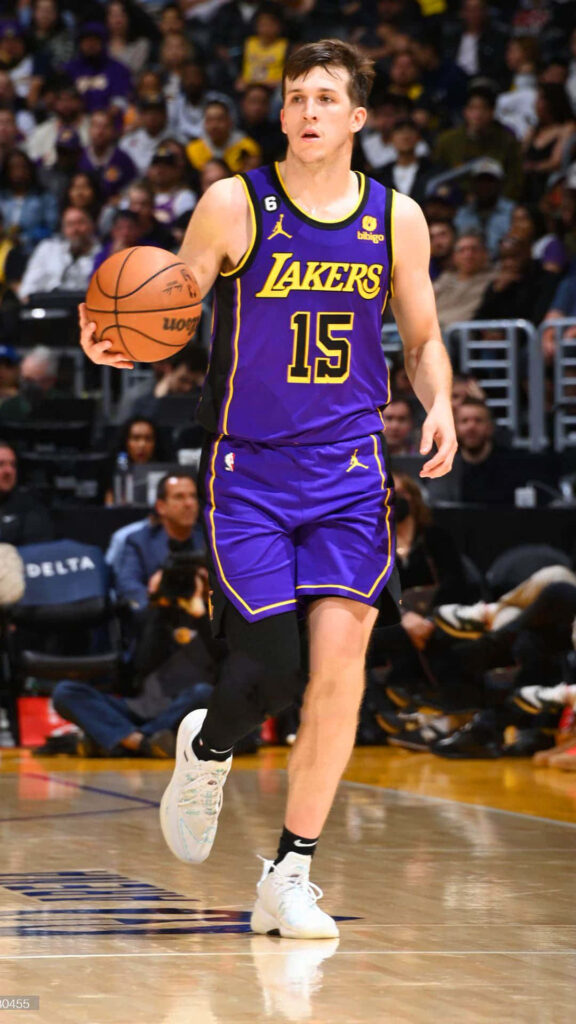 Austin Reaves Lakers dribbling basketball on court showcasing focus and athleticism wallpaper