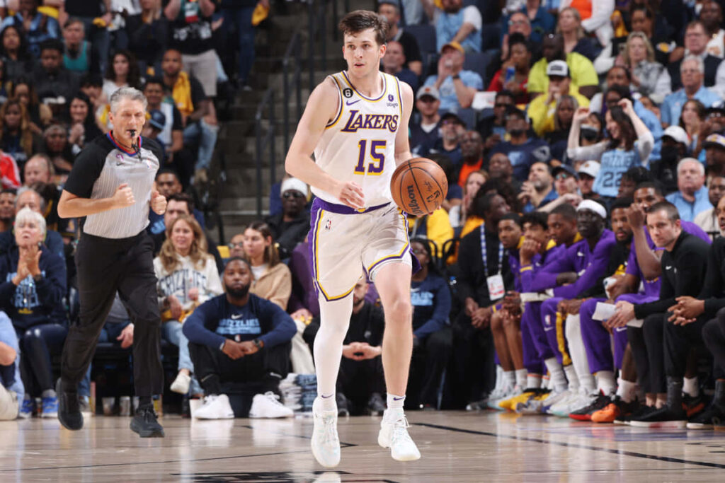 Austin Reaves Lakers dribbling basketball focused during game with crowd background wallpaper
