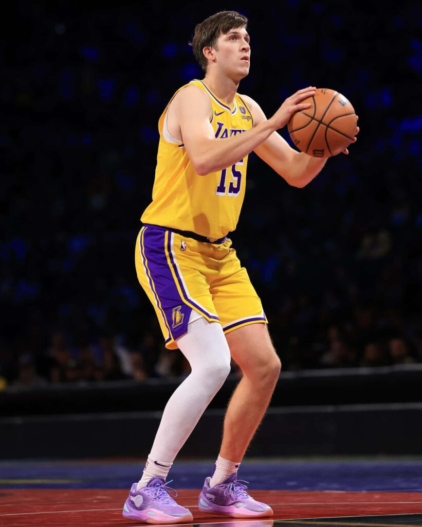 Austin Reaves Lakers uniform focused basketball shot intense game wallpaper background