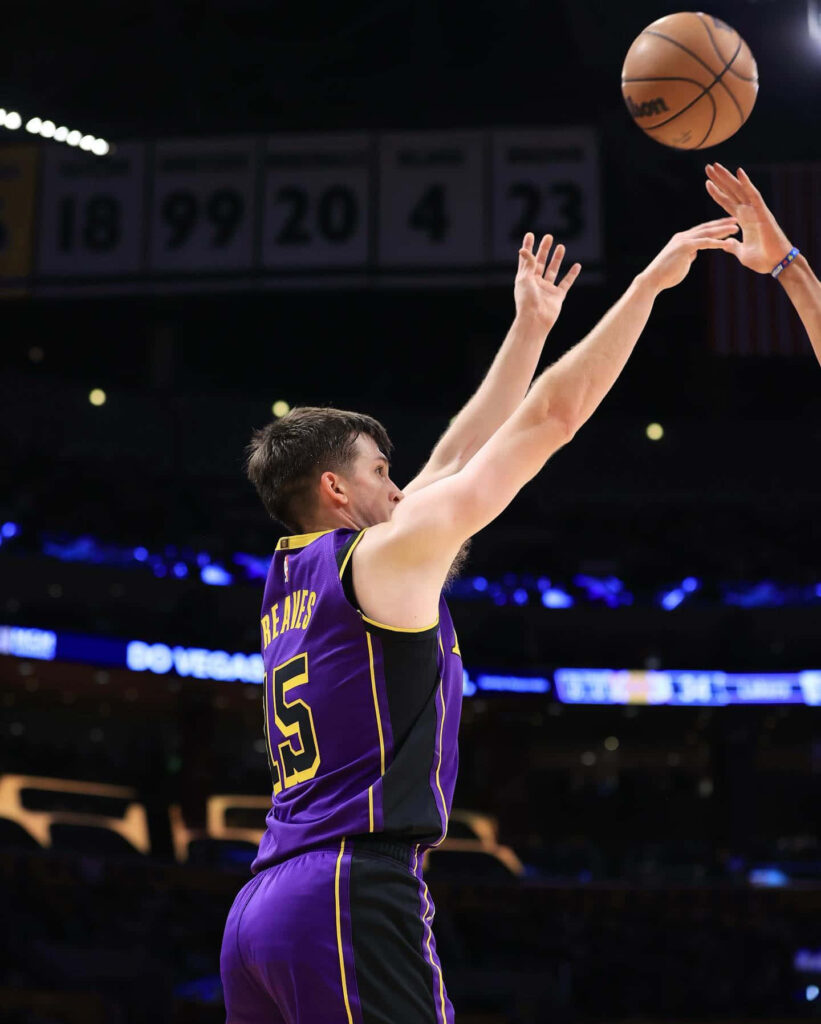 Austin Reaves Los Angeles basketball player shooting jump shot during intense game action wallpaper