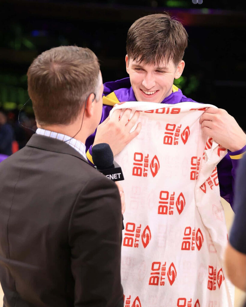 Austin Reaves smiling post game interview holding BioSteel towel on basketball court wallpaper background