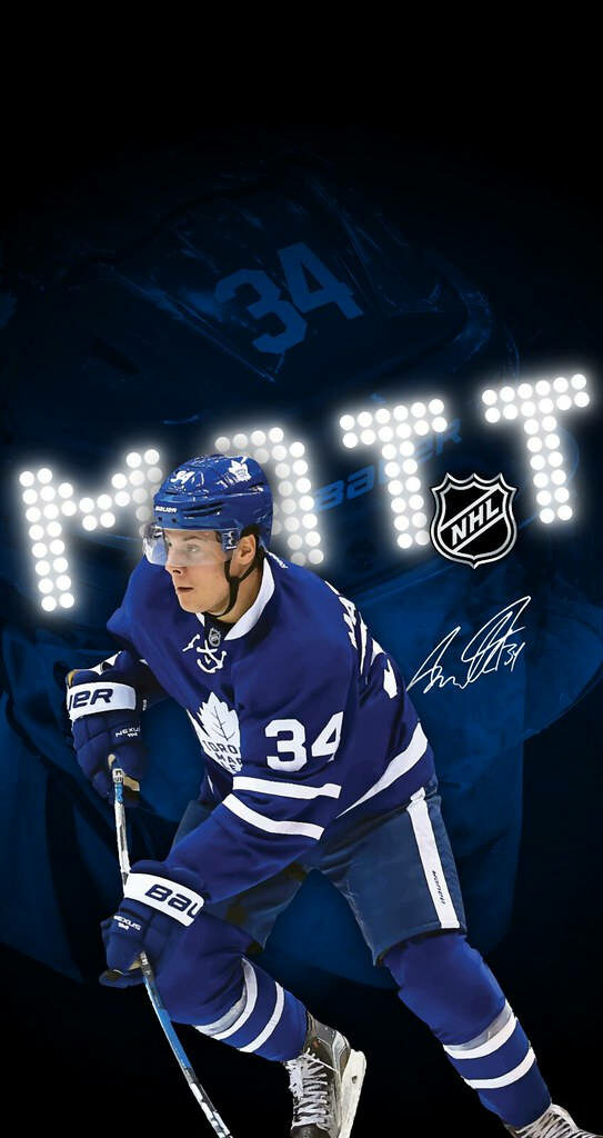 Auston Matthews Toronto Maple Leafs intense action shot focused expression jersey number background Wallpaper