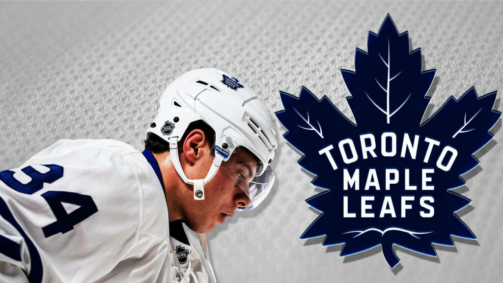 Auston Matthews in Toronto Maple Leafs uniform action shot with team logo hockey wallpaper background