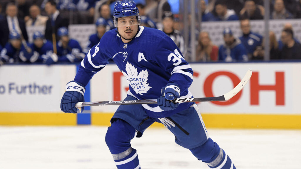 Auston Matthews Toronto Maple Leafs intense hockey action skating dynamic ice wallpaper