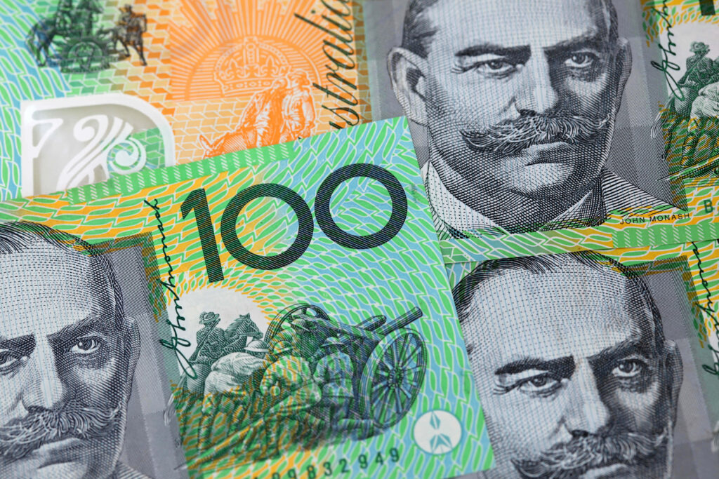 Close-up of Australian 100 dollar banknotes with detailed portraits and security patterns wallpaper