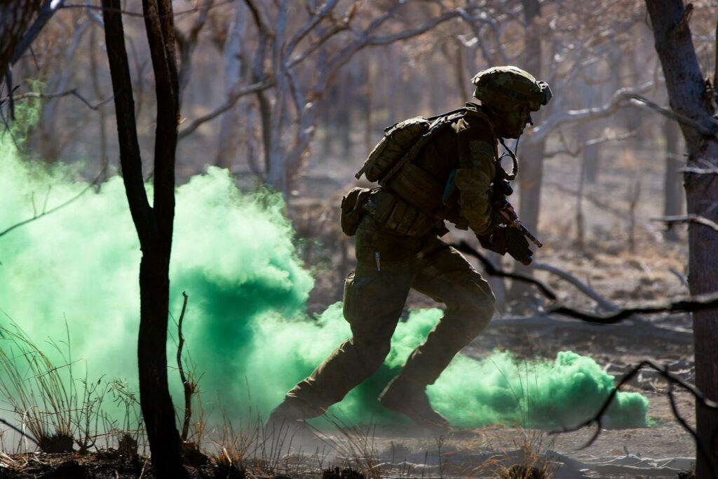 Armed Forces Down Under: Majestic Australian Soldiers Pose Amidst a Powerful Arsenal Wallpaper
