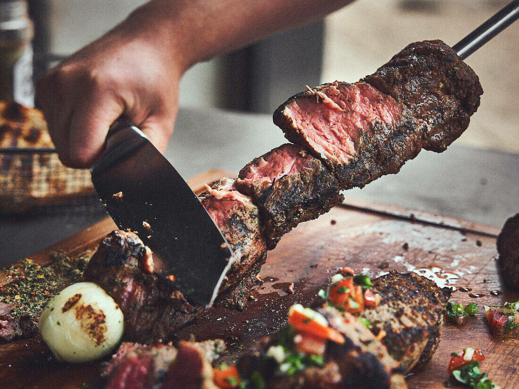 Authentic Brazilian Churrasco: Close-Up of Grilled Beef Wallpaper