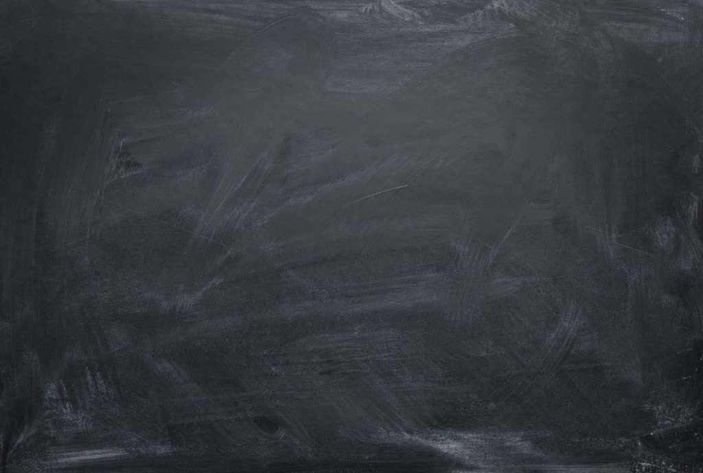 High-resolution worn blackboard texture with faded white chalk smudges for creative design Wallpaper