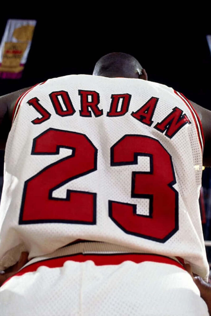 Paying Tribute to an Iconic Basketball Legend with an Authentic Michael Jordan Jersey Wallpaper