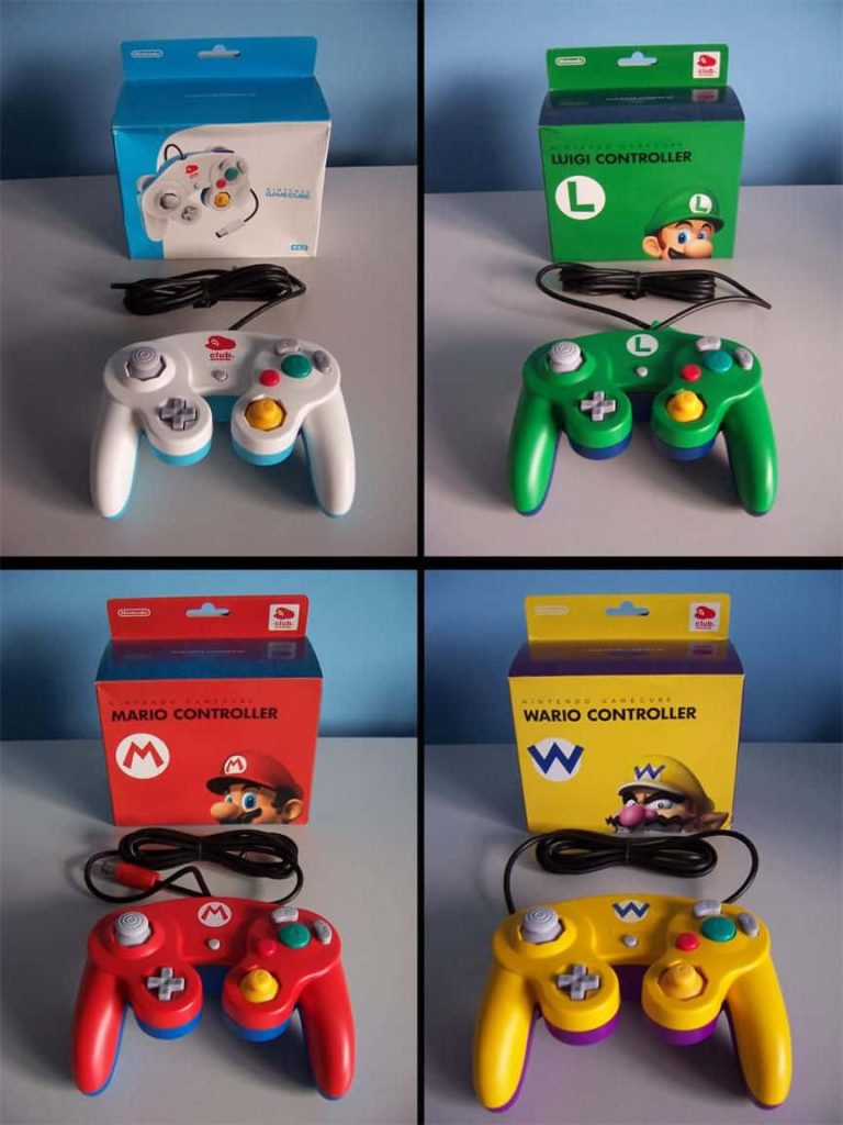 Four authentic Nintendo GameCube controllers with Mario Luigi Wario and Club Nintendo boxes wallpaper