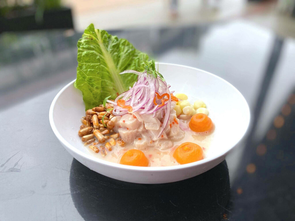 Authentic Peruvian ceviche with marinated fish red onions sweet potato and crispy corn nuts Wallpaper