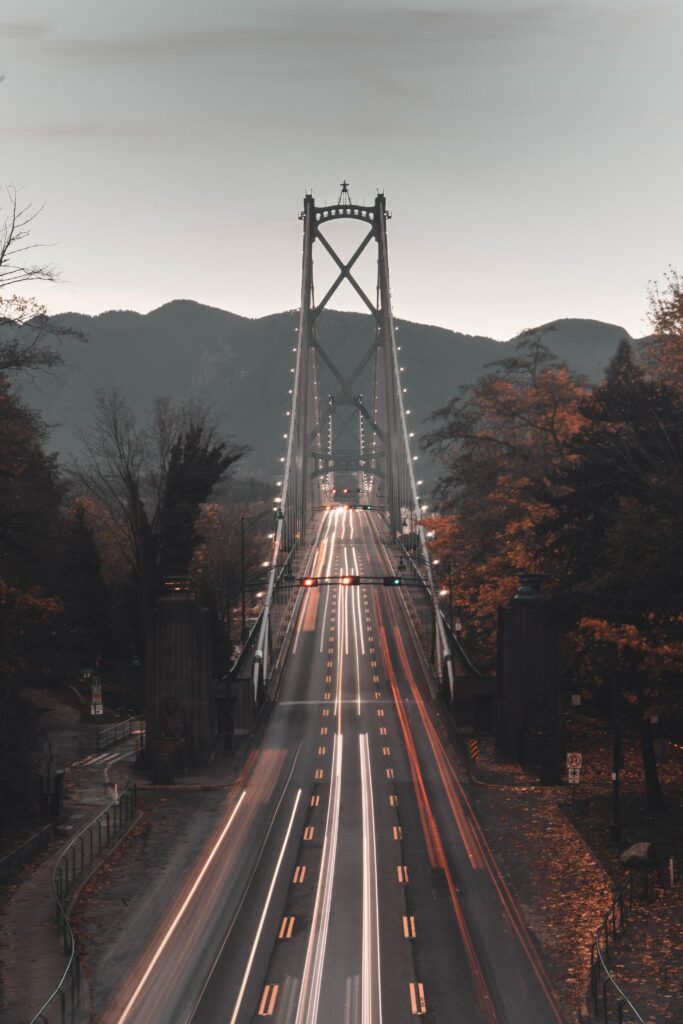 Captivating Aerial Bridge Wallpaper: Autumn Trees & Mountain Serenity