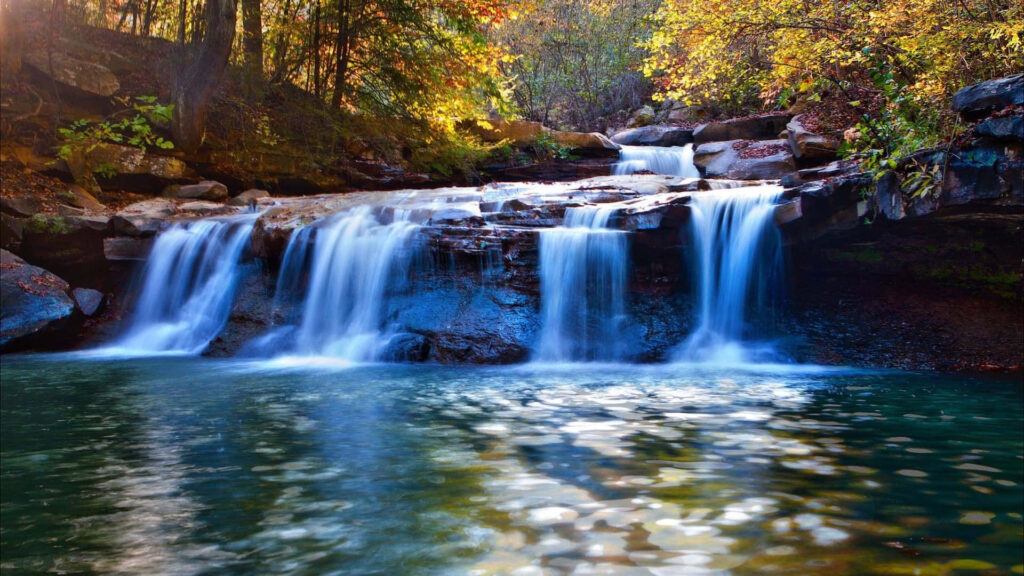 Autumn's Spectacular Display: Forest Waterfall Desktop Wallpaper