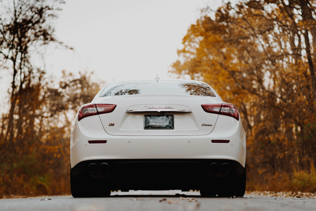 Sleek White Maserati Amid Autumn Foliage - Luxury Wallpaper Background