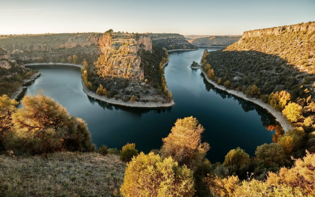 Autumn Symphony: A Majestic Sunset over the River Turn and Rocky Landscape Wallpaper
