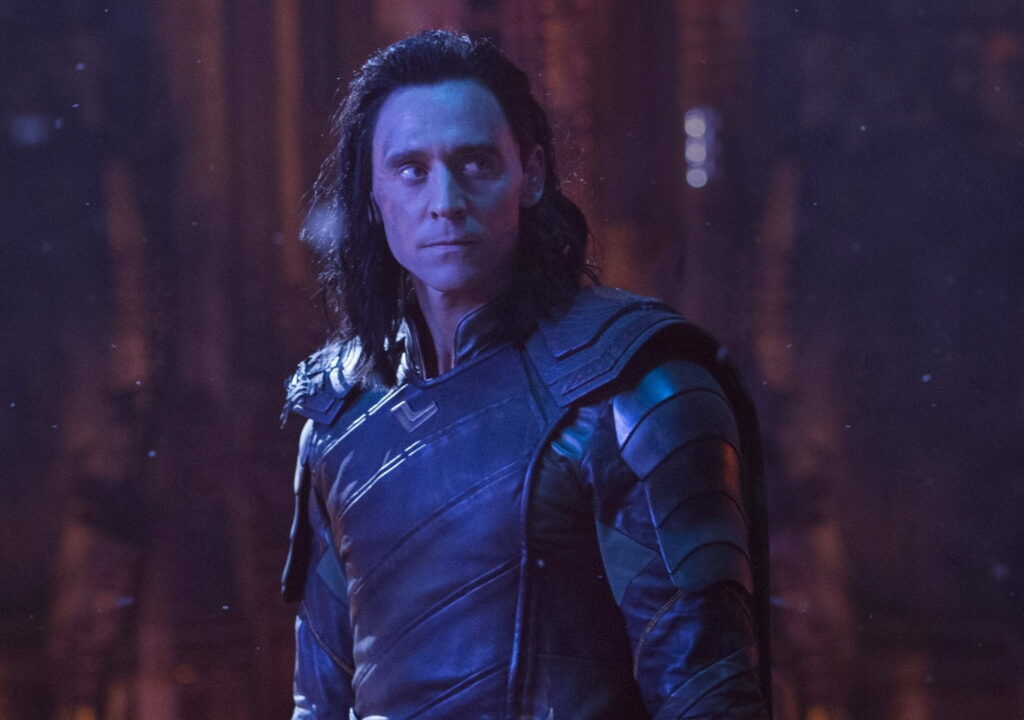 Tom Hiddleston as Loki in dark Asgardian armor with dramatic blue lighting Avengers wallpaper