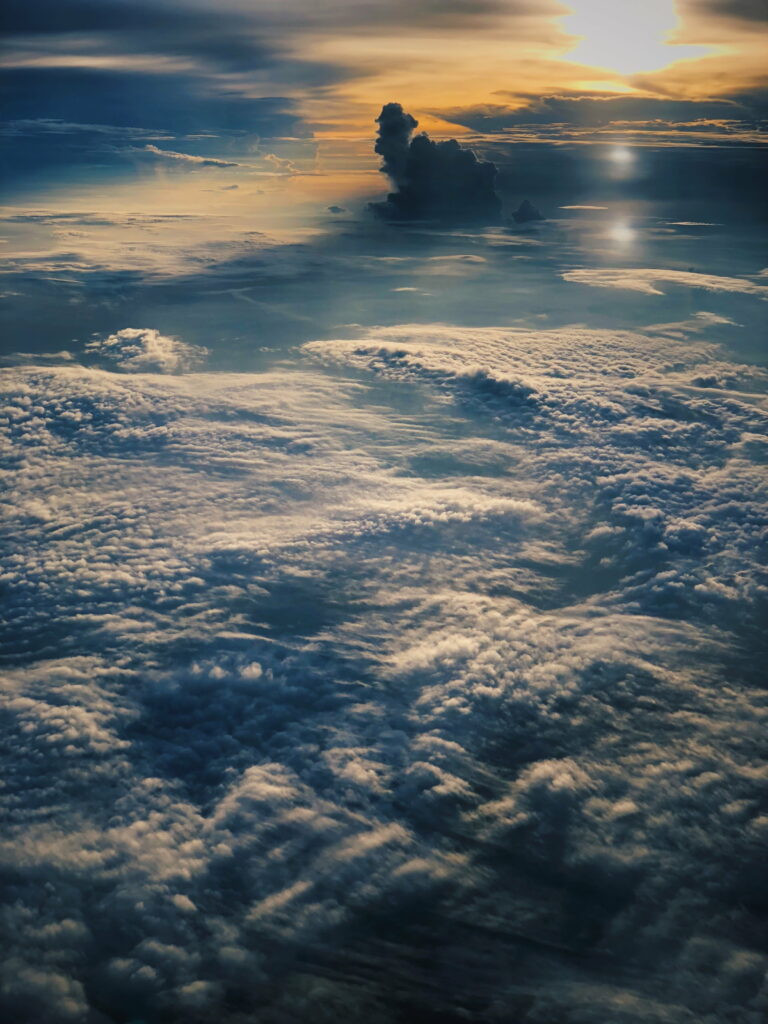 Serene Sunset Aerial View: HD Phone Wallpaper Above the Clouds