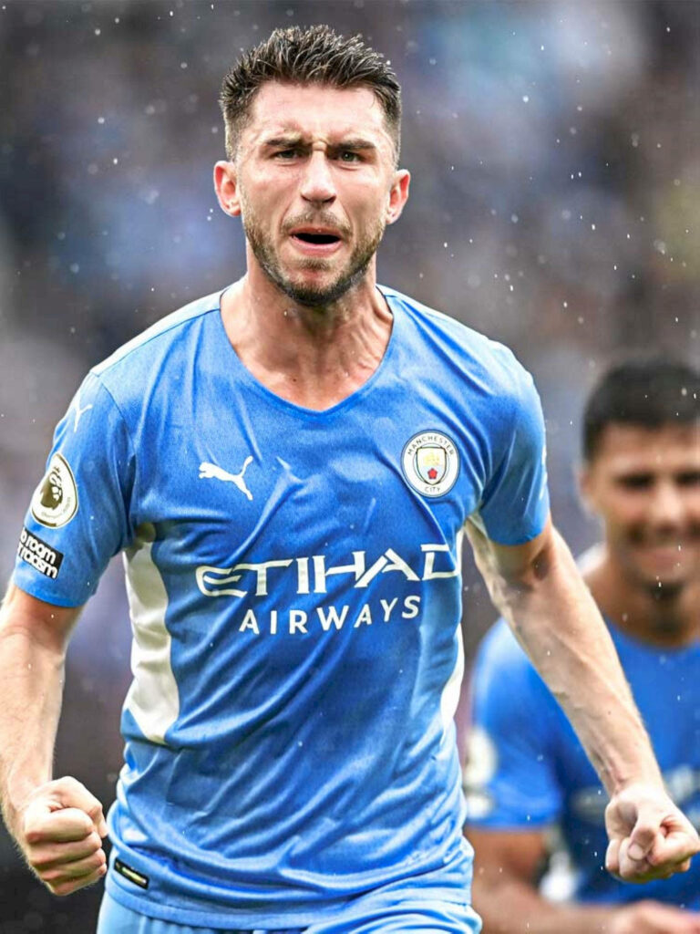 Aymeric Laporte celebrating passionately in Manchester City kit dynamic soccer wallpaper background