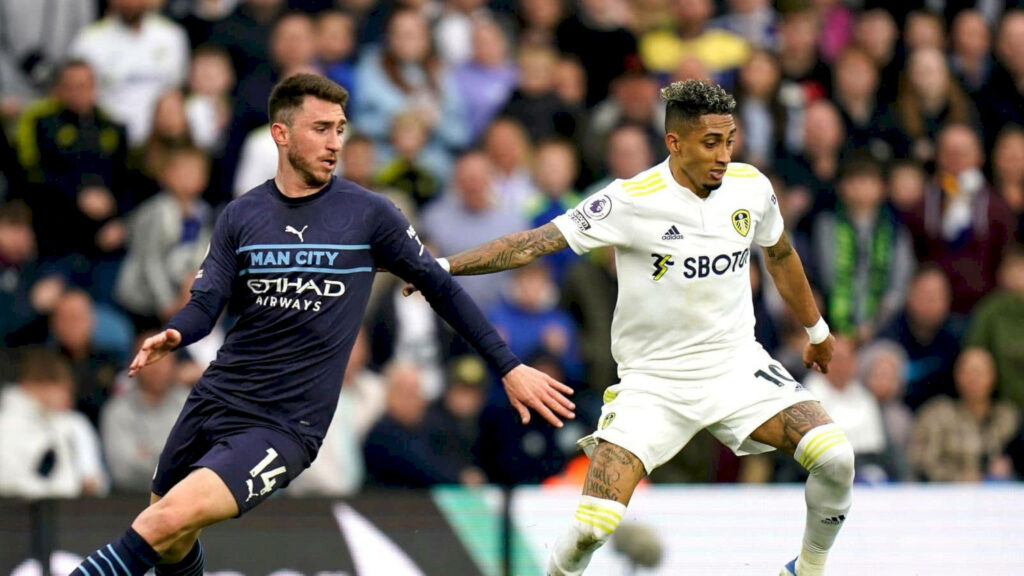 Aymeric Laporte intercepts ball showing defensive skills in intense football match wallpaper background