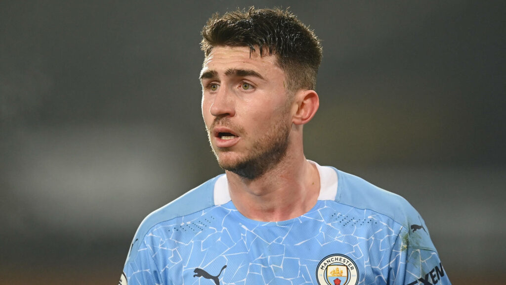 Aymeric Laporte focused in Manchester City jersey close-up football wallpaper background