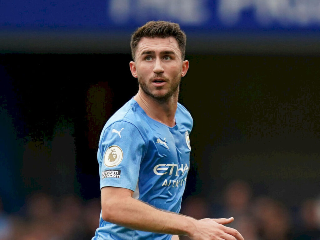 Aymeric Laporte in Manchester City kit looking upward during a football match wallpaper background