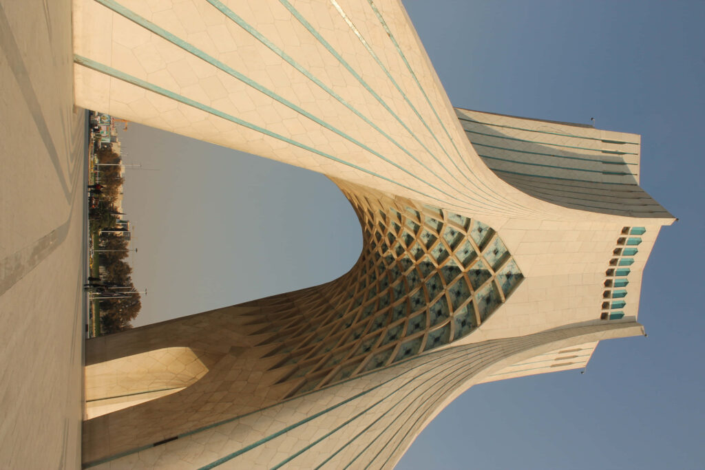 Side view of Azadi Tower Tehran showcasing geometric architecture and clear sky background Wallpaper