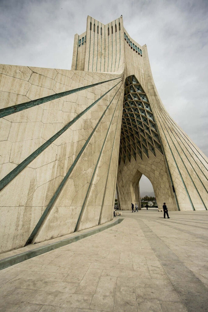 Angled view of Azadi Tower Tehran with geometric design and moody sky wallpaper background