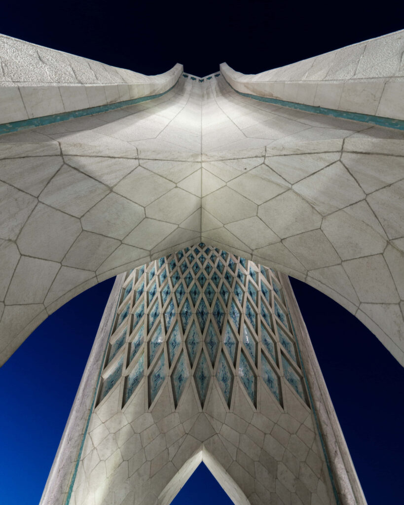 Azadi Tower Tehran Iran with intricate geometric patterns against deep blue sky background Wallpaper