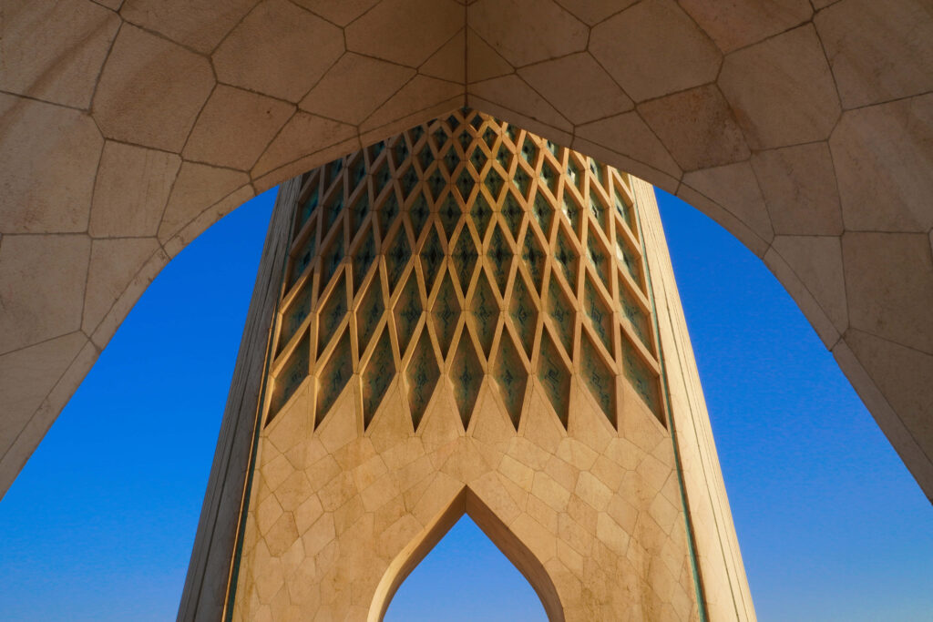 Azadi Tower Tehran wallpaper showcasing Islamic geometric design against clear blue sky background