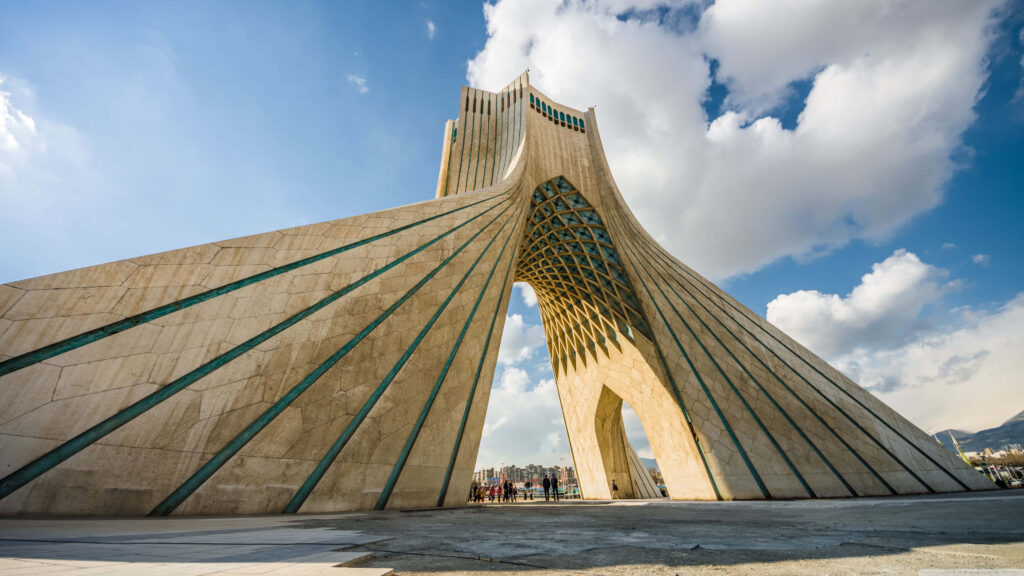 Azadi Tower Tehran with dramatic clouds and blue sky widescreen wallpaper background
