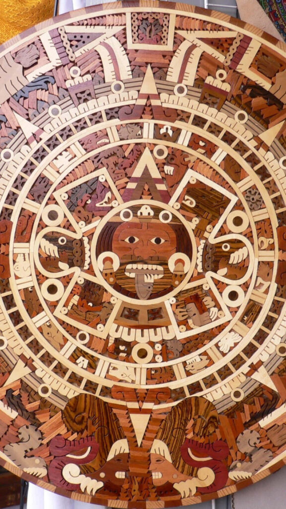 Aztec sun stone wallpaper with intricate traditional patterns in warm earthy tones background