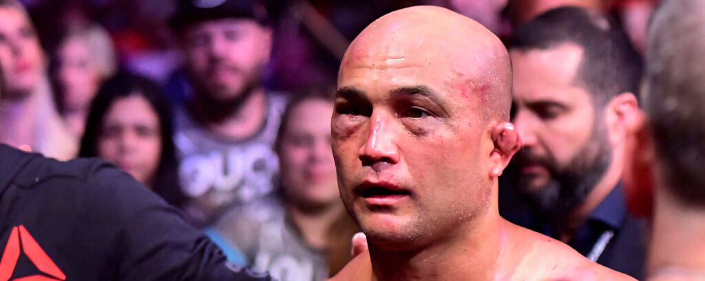 B.J. Penn showing bruised swollen face after intense MMA fight with wallpaper background