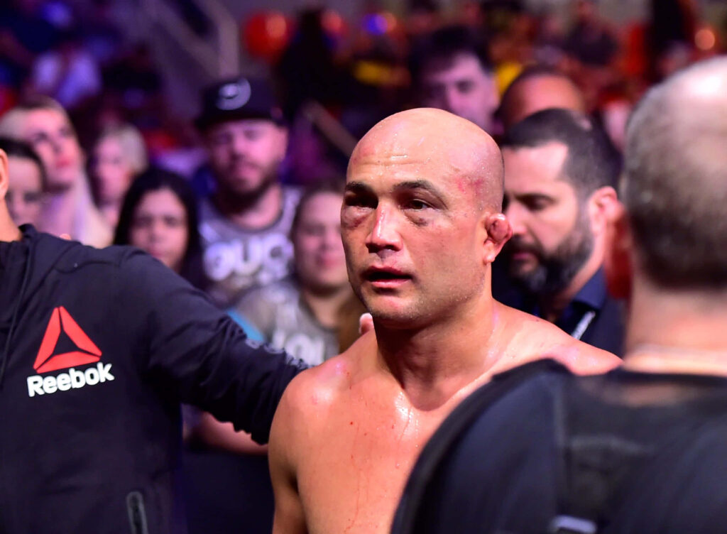 B.J. Penn walking from octagon with determined face surrounded by fans and coaches after fight Wallpaper