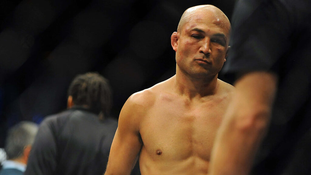B.J. Penn bruised and exhausted in the octagon during intense MMA battle wallpaper background