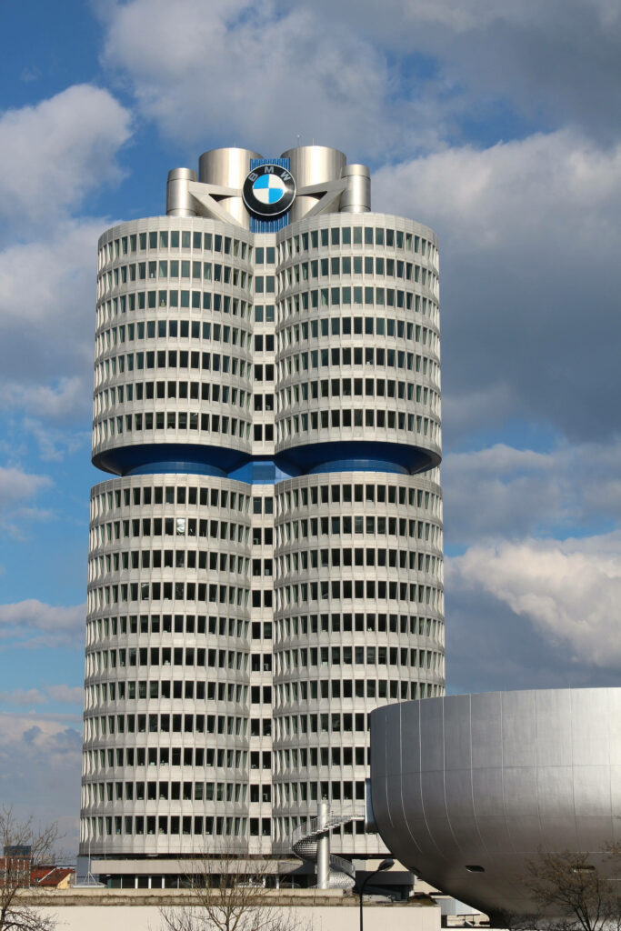 BMW Headquarters Munich four-cylinder architecture with partly cloudy sky wallpaper background