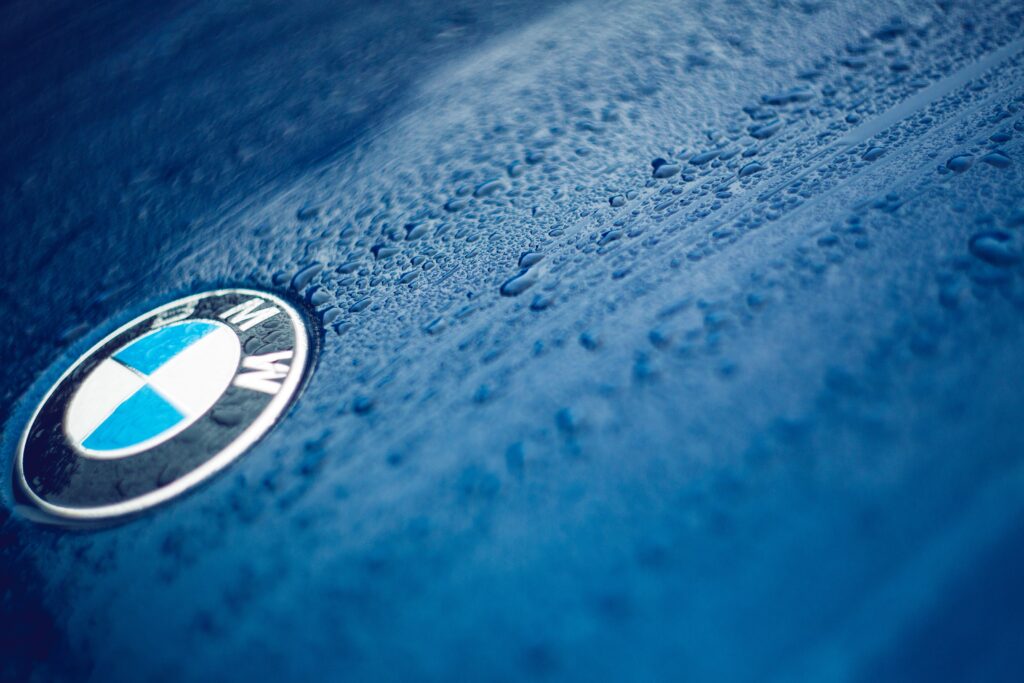 BMW Logo Close-Up: Elegant Blue Background with Water Droplets Wallpaper