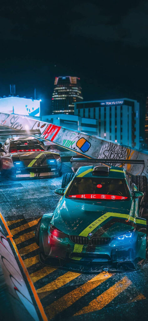 BMW M4 drift car under vibrant city lights with urban graffiti capturing midnight street racing Wallpaper