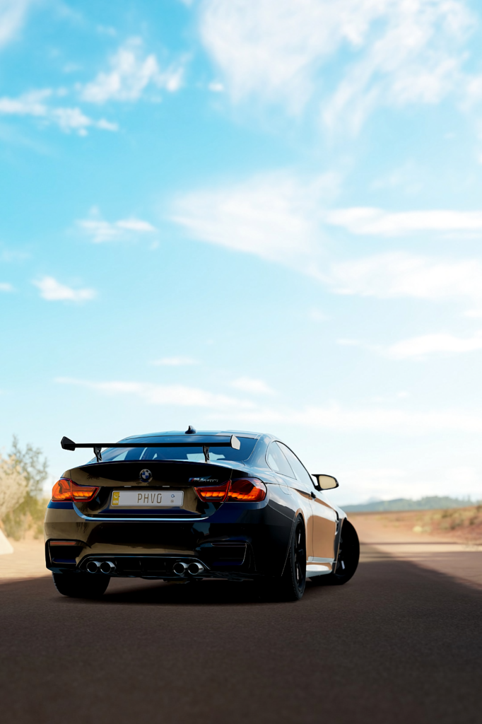 BMW M4 GTS Wallpaper: Sleek Supercar Against Bright Blue Sky