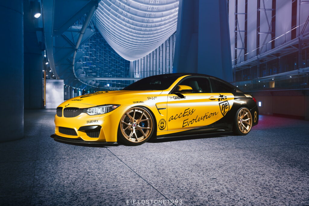 Yellow BMW M4 F82 with Access Evolution decals and black accents by Tokyo International Forum Wallpaper