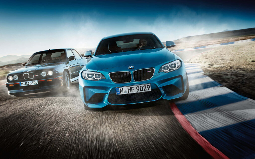 BMW cars racing dynamically on a winding track high-performance automobiles wallpaper background