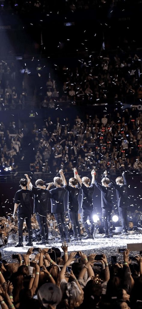 BTS concert silhouette stage with falling confetti dramatic lighting and cheering crowd wallpaper