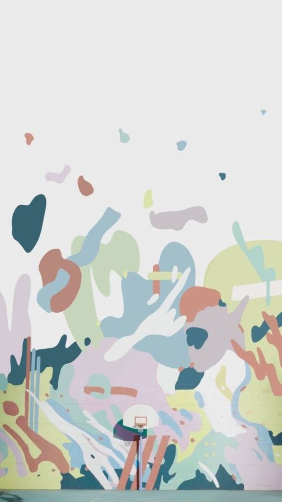 Minimalist BTS Dynamite wallpaper with pastel paint splashes and basketball hoop on white wall