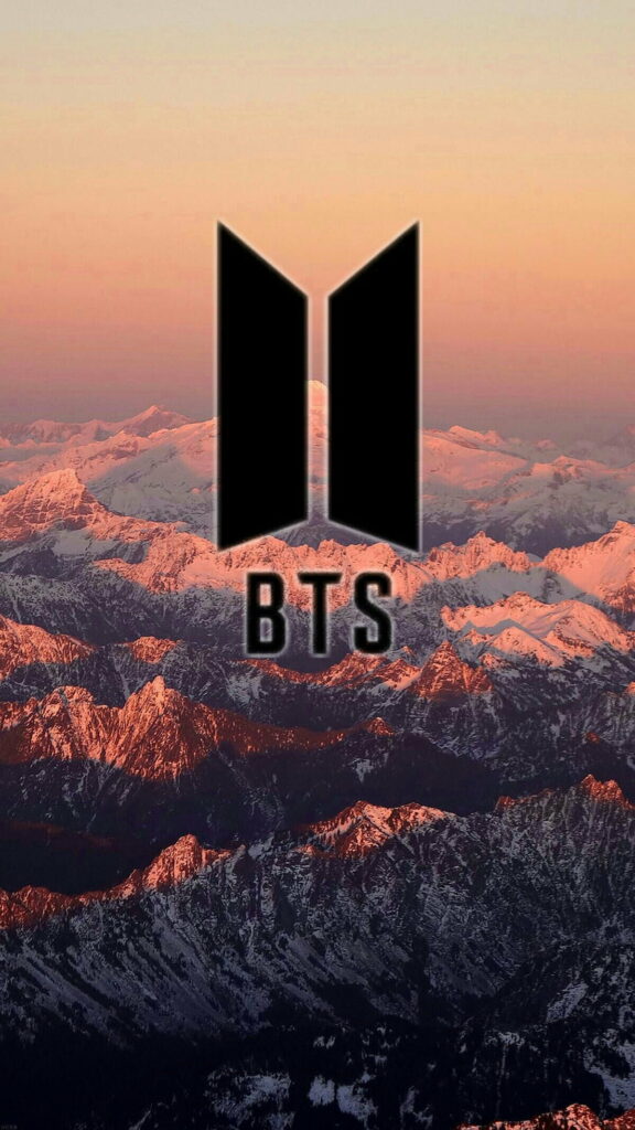 BTS black logo centered on snowy mountain range with warm golden sunset wallpaper background