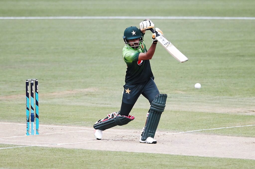 Babar Azam batting skillfully on cricket field showcasing expert technique wallpaper background