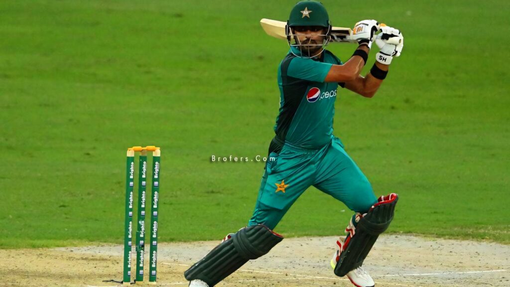 Babar Azam playing cricket in Pakistan team uniform poised to hit a shot on field wallpaper