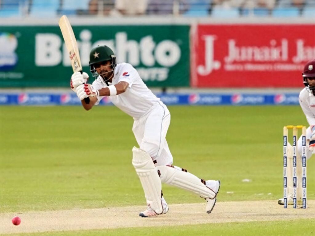 Babar Azam in white cricket uniform batting during test match focused skilled shot wallpaper