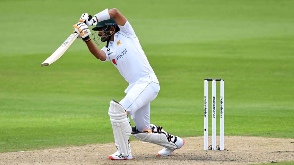 Babar Azam cricket action wallpaper hitting a powerful shot showcasing dynamic batting skills