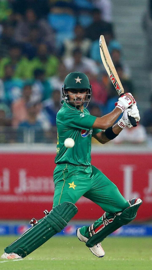 Babar Azam batting fast ball in green Pakistan cricket uniform showing skill and focus Wallpaper