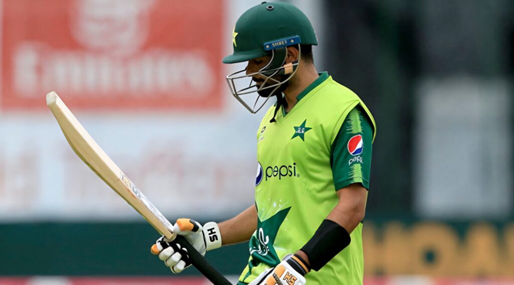 Babar Azam in green Pakistan cricket jersey focused with bat on field wallpaper background