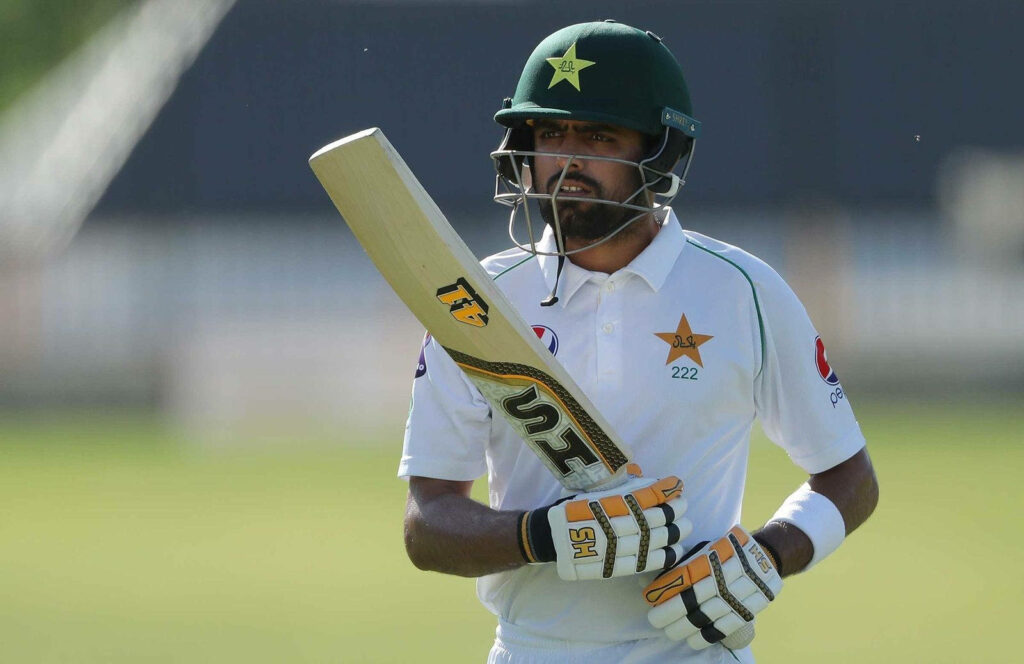Babar Azam Pakistan cricket captain in official test uniform holding bat confident pose wallpaper